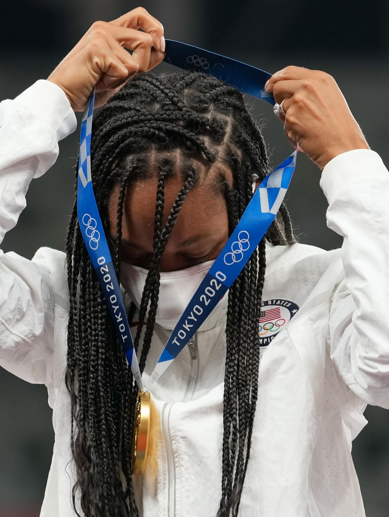 Allyson Felix places her gold medal around her neck